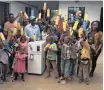  ??  ?? COMMUNITY members celebrate Beth Koigi’s success with harvesting water from condensati­on.