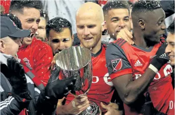  ?? VAUGHN RIDLEY/ GETTY IMAGES ?? Toronto FC’s Michael Bradley looks at the MLS Eastern Conference Finals trophy following victory in the second leg of their second round matchup against Columbus Crew SC, at BMO Field on Nov. 29.