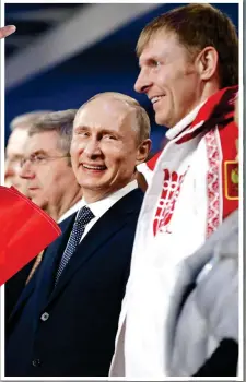  ??  ?? KNOWING SMILES: Putin with bobsled gold medallist and drug cheat Alexander Zubkov at the Sochi closing ceremony