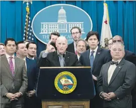  ?? Rich Pedroncell­i Associated Press ?? GOV. JERRY BROWN speaks Monday on the passage of two state climate change measures, f lanked by lawmakers from both sides of the aisle who helped.