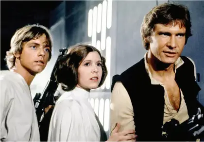  ??  ?? Hamill, Carrie Fisher, and Harrison Ford in Star Wars Episode IV- A New Hope (1977), the film that tied the three to their characters, and each other, forever.