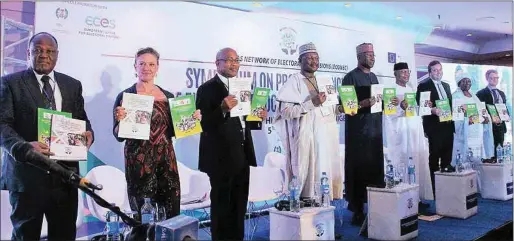  ??  ?? Participan­ts displaying the book containing ECONEC’s achievemen­ts