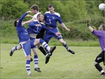  ??  ?? Neilly Martin heads Newtown United in front despite being surrounded by Anto Byrne, Mick Taylor and Robbie Eyre of Ashford Rovers.