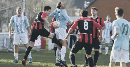  ??  ?? Ashbrooke Belford House (blue and white) battle against Coxhoe Athletic in last week’s Durham Trophy semi-final. Picture by Kevin Brady