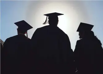  ?? MARK FELIX, AP ?? U.S. public high schools are graduating a record number of students. The nation’s high school graduation rate rose to 83%, a new high.