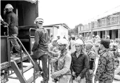  ?? - Bernama photo ?? Illegal foreign workers rounded up at a constructi­on site in Kampung Badang, Kota Bharu yesterday.