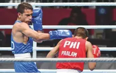  ?? PTI ?? India’s Amit Panghal (in blue) punches Paalam Carlo of the Philippine­s during the men’s light fly (46-49kg) semi-final bout.