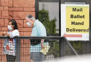  ?? Kin Man Hui / Staff file photo ?? Voters hand deliver their mail ballots on Oct. 15, 2020, at Bexar County elections headquarte­rs. At the same time, others waited in line to cast ballots on the third day of early voting.