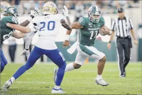  ?? Joe Robbins / Getty Images ?? Connor Heyward of Michigan State advances the ball against Tulsa on Friday. He caught a touchdown pass on the Spartans’ first possession.