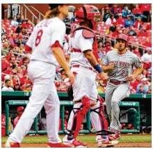  ?? DILIP VISHWANAT / GETTY IMAGES ?? The Reds’ Adam Duvall scores in the seventh inning Sunday at Busch Stadium in St. Louis. Duvall had four hits, including three doubles, and an RBI in the win.