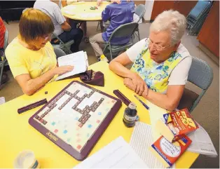  ??  ?? ADOLPHE PIERRE-LOUIS/JOURNAL Maria Due, left, and Linda Gassaway play Scrabble at Palo Duro Senior Center.