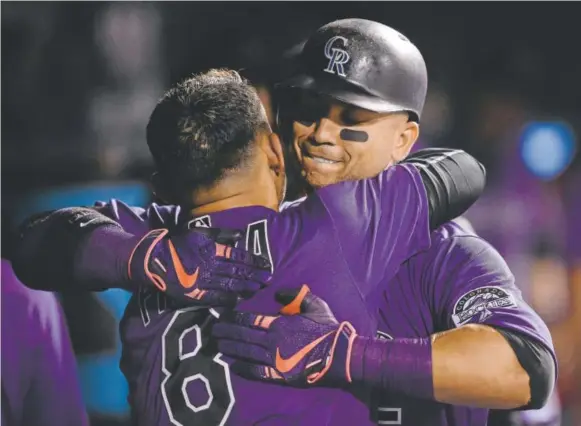  ?? Getty Images ?? Carlos Gonzalez, right, and Gerardo Parra hug after Gonzalez’s solo home run in the fifth inning against Milwaukee. Parra also hit a homer in the fifth.