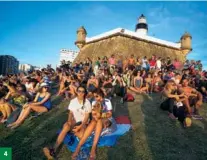  ?? WANG MIAO / FOR CHINA DAILY ?? 4
4. Tourists rest on a lawn near a historic lamp tower in Salvador.