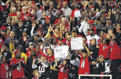  ?? KEVIN C. COX / GETTY IMAGES ?? Falcons fans celebrate a touchdown during the first half against the New Orleans Saints at the Georgia Dome on Jan. 1. Atlanta coach Dan Quinn wants his crowd to be somewhat rowdy.