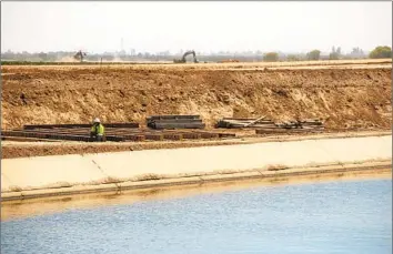  ?? BRIAN VAN DER BRUG Los Angeles Times ?? A SECTION OF the 152-mile Friant-Kern Canal is under constructi­on in Terra Bella, Calif., last summer after being damaged from subsidence, which is when the removal of groundwate­r causes the earth to sink.