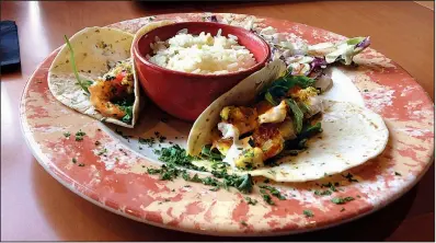  ?? Arkansas Democrat-Gazette/PHILIP MARTIN ?? Grilled shrimp tacos at Copper Grill come with a peppy jicama slaw.
