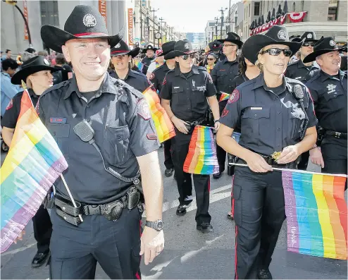  ?? LYLE ASPINALL / POSTMEDIA NEWS FILES ?? The Calgary Police Service participat­es in the Pride Parade in downtown Calgary in 2014.