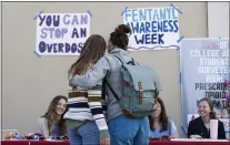  ?? ?? Students chat at an informatio­n table set up to spread awareness about the dangers of fentanyl at Santa Clara University on May 9. That and the installati­on of a vending machine that dispenses Narcan are part of a plan to make students aware of the drug.