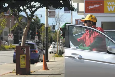  ?? Brandon Chew / The Chronicle ?? A proposed project would replace a car wash and gas station at Oak and Divisadero streets with 186 units.