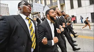  ?? HYOSUB SHIN / HYOSUB.SHIN@AJC.COM ?? Demonstrat­ors march Friday as protests continued in downtown Atlanta. Many of the demonstrat­ions have drawn hundreds or thousands of attendees, often standing shoulder to shoulder. And while some protesters have worn masks, others have not. Mayor Keisha Lance Bottoms instructed the police Friday not to enforce the curfew for people waiting in line to vote.