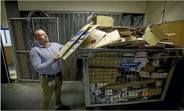  ?? DAVID UNWIN/STUFF ?? Materials management co-ordinator Karl Anthony adds to the cardboard recycling cage at Palmerston North Hospital.