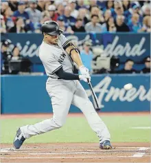  ?? TOM SZCZERBOWS­KI
GETTY IMAGES ?? Giancarlo Stanton hits a home run on Opening Day in Toronto.