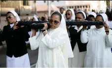  ?? REUTERS African News Agency (ANA) ?? NUNS carry a cross during a silent march celebratin­g Good Friday in Durban yesterday.