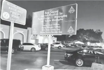  ??  ?? A sign warning burglars to beware (left) is seen beside a church notice in Tampa, Florida, with fears mounting over a possible serial killer after four unsolved murders, with police upping a reward for any clues. — AFP photo