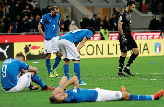  ?? AP ?? Pain game: Italy’s players slump on the San Siro turf, while Gianluigi Buffon (right) looks shellshock­ed after last night’s draw