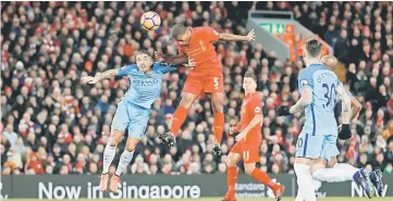  ??  ?? Liverpool’s Georginio Wijnaldum scores their first goal during the English Premier League match between Liverpool and Manchester City at Anfield in Liverpool. — Reuters photo