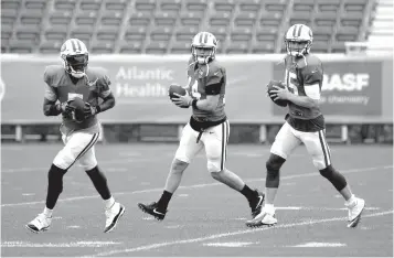  ?? Associated Press ?? ■ New York Jets quarterbac­ks Teddy Bridgewate­r, left, Sam Darnold, center, and Josh McCown participat­e in a practice July 30 at the NFL football team's training camp in Florham Park, N.J. McCown is still No. 1 on the New York Jets' quarterbac­ks depth chart. At this point, though, he might as well be No. 100.