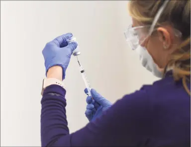  ?? Tyler Sizemore / Hearst Connecticu­t Media ?? A nurse prepares the Moderna COVID-19 vaccine during the grand opening of the vaccine “super site” at Silicon Harbor in Stamford on March 15.