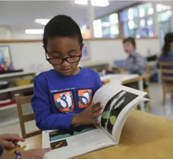  ?? RICHARD LAUTENS/TORONTO STAR ?? The Montessori school system encourages kids of different ages to interact and learn from each other.