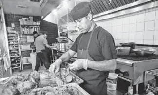  ?? PHOTOS BY MICHAEL SCHENNUM/THE REPUBLIC ?? Chef Adolfo Heredia prepares braised beef tongue at Tuck Shop for an upscale version of McDonald’s McRib sandwich. The TuckRib is one of the dishes it’s bringing to Devoured.