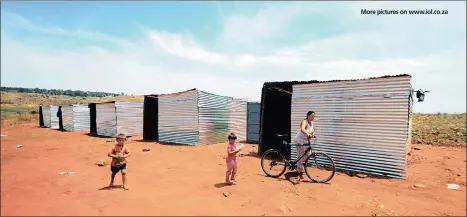  ??  ?? More pictures on www.iol.co.za
ROUGH RIDE: A woman with her children outside their shack in Munsievill­e township in Krugersdor­p after they were evicted from Coronation Park.