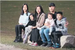  ?? STEVE RUSSELL TORONTO STAR ?? The eyes of Muni Cao’s kids lit up when they got their gift boxes from the Santa Claus Fund. The family moved from Peru to Canada in 2014. From left: Celine, 14; Victoria, 4; Chao; her husband, Chiming Ye, holding Kate, 1; and Kensen, 10.