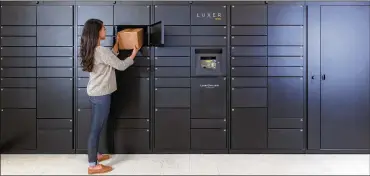  ?? LUXER ONE ?? A woman removes a package from one of Luxer’s access lockers in San Francisco. Luxer One provides secure lockers in buildings in the United States and Canada that can be accessed by both delivery companies and residents.