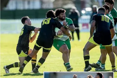  ??  ?? Manawatu¯ Mustangs prop Gordy Karaitiana, centre, takes on the heart of the Wellington Orcas defence at Fitzherber­t Park on Saturday.