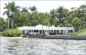  ?? KERRY SHERIDAN/AFP ?? A low-lying home near sea level in the Indian Beach neighbourh­ood of Sarasota, Florida, last week.