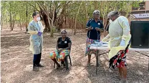  ?? MIWATJ HEALTH ABORIGINAL CORPORATIO­N ?? Health workers practice remote outbreak response measures at an Aboriginal health clinic in Raminginin­g, in Australia’s Northern Territory, last year.