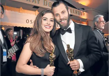  ??  ?? Strong Silent types? Rachel Shenton and Chris Overton with their golden statuettes.