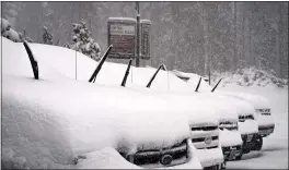  ?? CHRISTIAN PONDELLA — MAMMOTH MOUNTAIN SKI AREA VIA AP ?? In this photo provided by Mammoth Mountain Ski Area, falling snow collects on cars in a parking lot at Mammoth Mountain, Monday in Mammoth Lakes