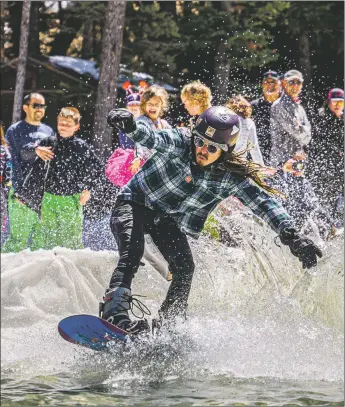  ?? NATHAN BURTON/Taos News ?? A competitor rides across the water during the pond skimming competitio­n at Sipapu Summer and Ski Resort Saturday (April 2).