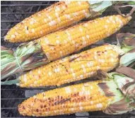  ?? JAN UEBELHLERR ?? Cooking sweet corn over coals gives it a smoky flavor and a charred look.