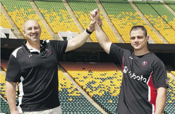  ?? IAN KUCERAK ?? Former rugby star Al Charron, left, of Ottawa, raises the arm of Brantford’s Aaron Carpenter, who is poised to break Charron’s national record for internatio­nal caps Saturday in a test match against Romania at Ellerslie Rugby Park.