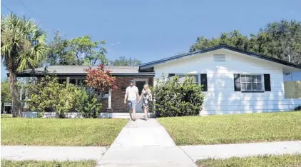  ?? SCOTT KEELER/TAMPA BAY TIMES ?? The former home of the late author Jack Kerouac was renovated by then-owners Paige and Frank Viggiano, of The Flip Side LLC, shown leaving it and for sale at 5169 10th Ave. N., in 2020, in St. Petersburg. Ken Burchenal, a retired literature professor, purchased the home with his wife, Gina, for $360,000 in 2020. The Beat Generation legend was known for wandering, and his family ties drew him to Florida again and again.
