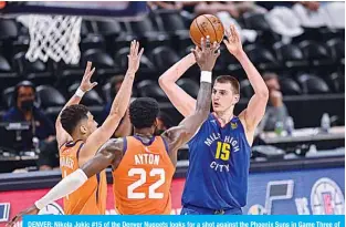  ?? —AFP ?? DENVER: Nikola Jokic #15 of the Denver Nuggets looks for a shot against the Phoenix Suns in Game Three of the Western Conference second-round playoff series at Ball Arena on Friday.