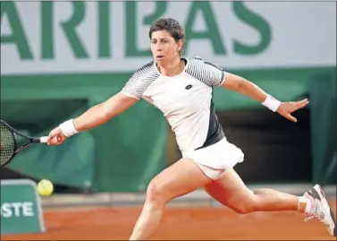  ??  ?? Carla Suárez persigue una pelota durante su partido de primera ronda en Roland Garros.