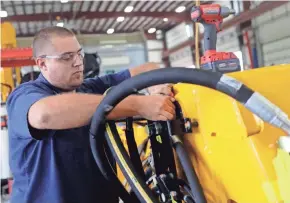  ?? SARAH KLOEPPING/USA TODAY NETWORK-WISCONSIN ?? Wesley Immel, testing technician for Wausau Equipment Co., builds a SnoDozer on Sept. 25 at the Fond du Lac airport products facility.