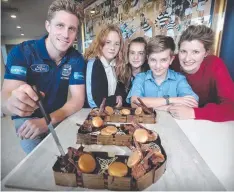  ?? Picture: GLENN FERGUSON ?? HAPPY BIRTHDAY: Scott Selwood, with Year 7 Western Heights College students Miranda Mels, Unesa Ibrahimi and Noah Brown, and the Cats’ community developmen­t general manager Sarah Albon, at the community centre yesterday.